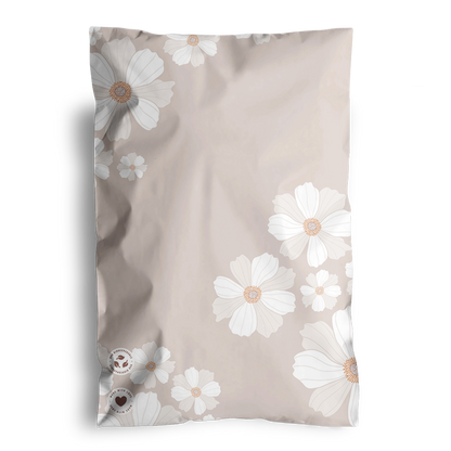 Floral patterned blanket or throw with a white and beige color scheme, packaged in impack.co Cosmos Biodegradable Mailers 6" x 9".