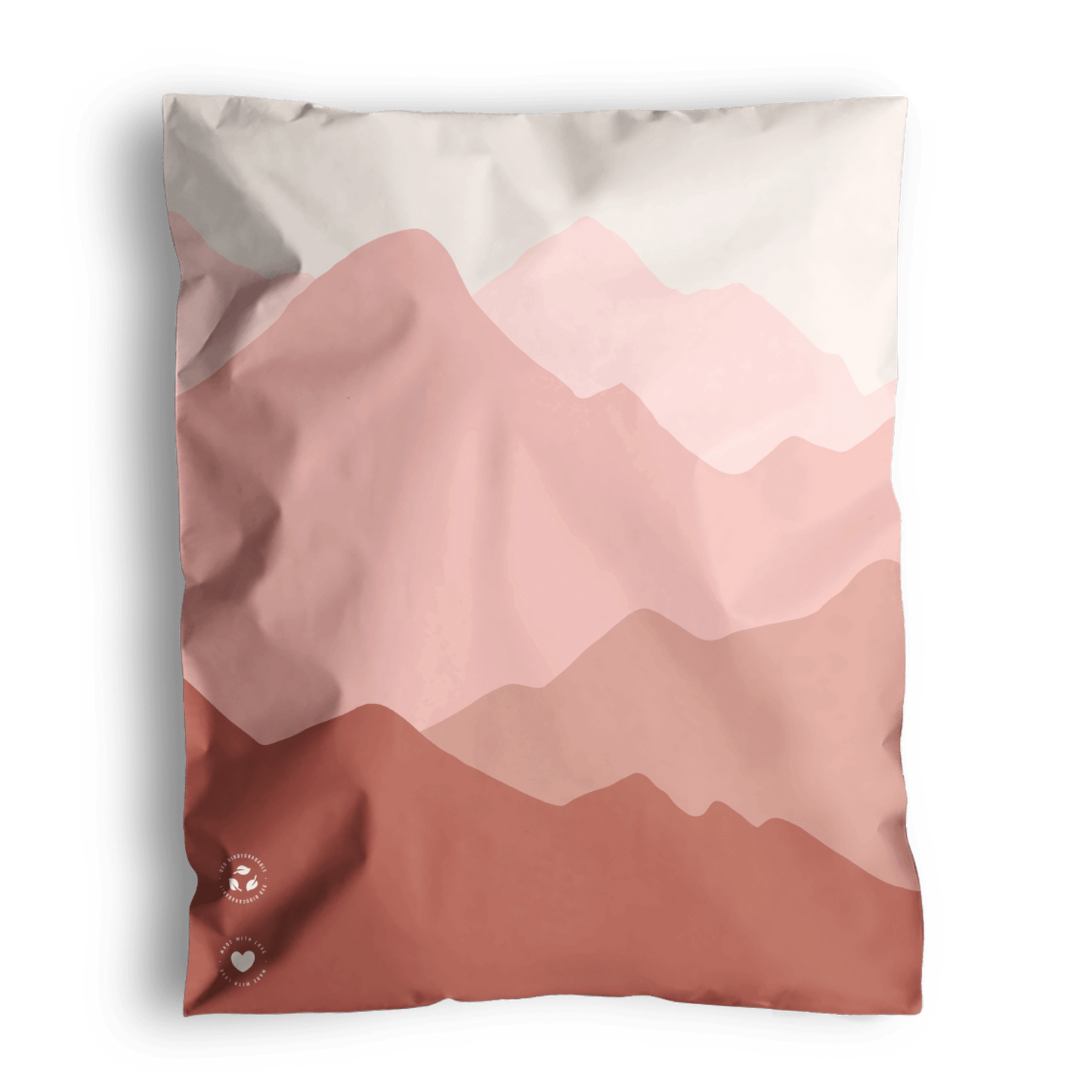 A graphic print cushion with a mountain landscape design in shades of pink and white, shipped in impack.co Mountain Clay Mailers 10" x 13".