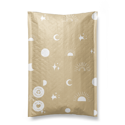 Illustration on impack.co Celestial Padded Paper Mailers 6" x 9" with celestial patterns including stars, moons, and suns, featuring a dripping black ink effect on the top right corner.