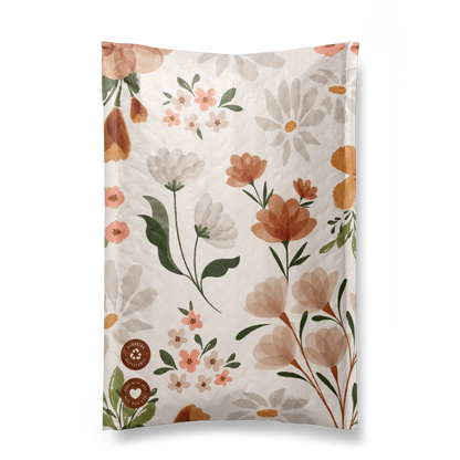 A Gardenlumina Padded Paper Mailers 6" x 9" with curled pages, featuring a design of various flowers and leaves in soft colors on FSC-Certified Paper.