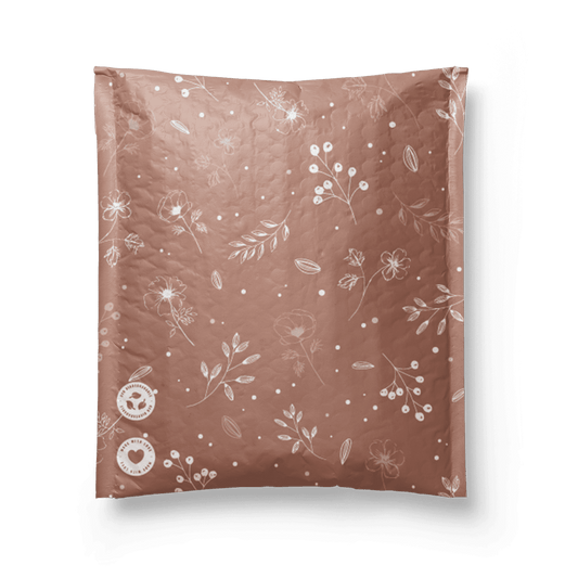 A Rosy Brown Biodegradable Bubble Mailer 6" x 9" with a floral pattern on it from impack.co.