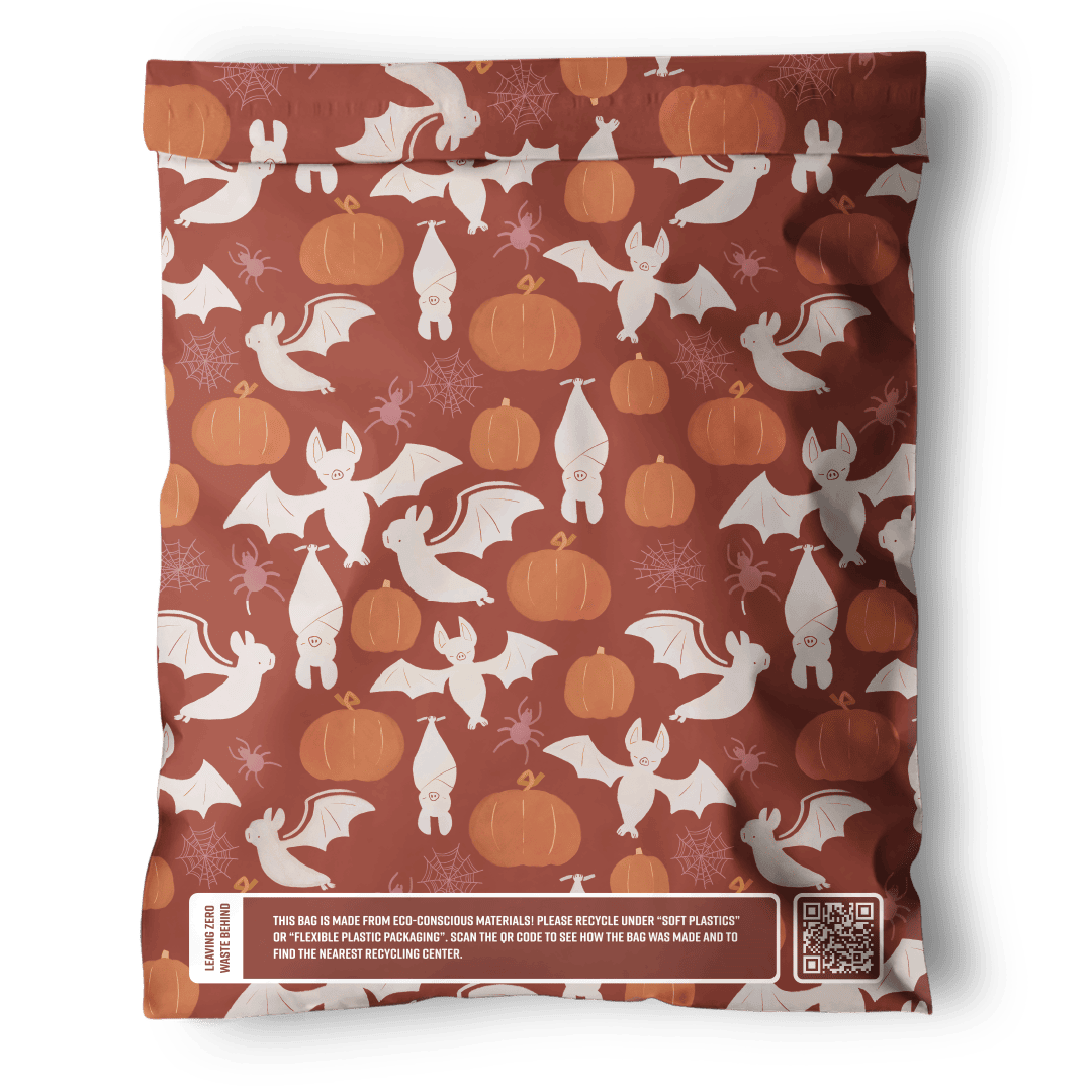 Introducing the SALE - Halloween Bats Mailers from impack.co: a rust-colored, eco-friendly mailer featuring a whimsical print of white bats, pumpkins, and snowflakes. Includes a QR code noting its durable transit protection. Size: 10" x 13".