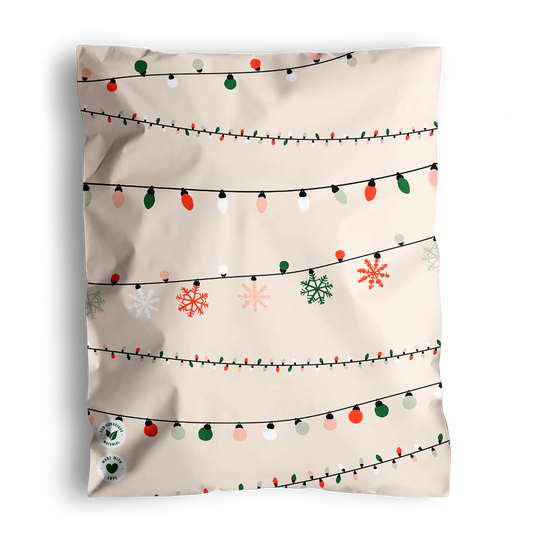 Holiday-themed bedding with impack.co Christmas Light Strings Biodegradable Mailers 10" x 13 Print and snowflake pattern.