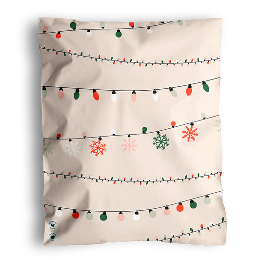 A festive pillow with impack.co Christmas Light Strings Biodegradable Mailers 14.5" x 19" design and snowflakes.