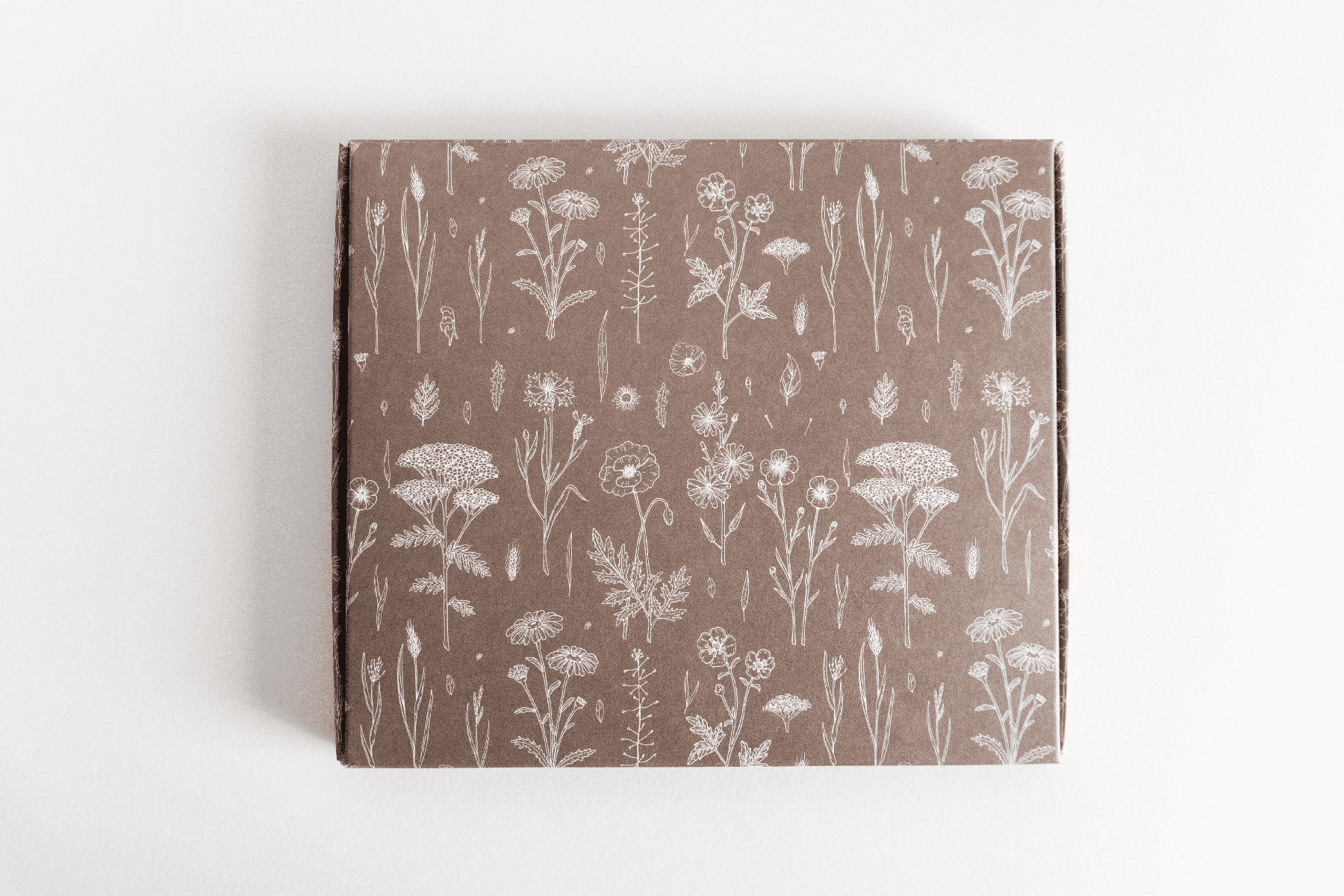 A brown ABC Box Wildflower 7" x 8" - Large notebook with a Wildflower pattern on it by impack.co.
