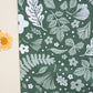 A green and white fabric with flowers and leaves on it, suitable for Emerald Evergreen Biodegradable Mailers 10" x 13" from impack.co.
