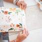 A woman is creating a Gardenlumina Padded Paper Mailers 10" x 13" bag from impack.co.