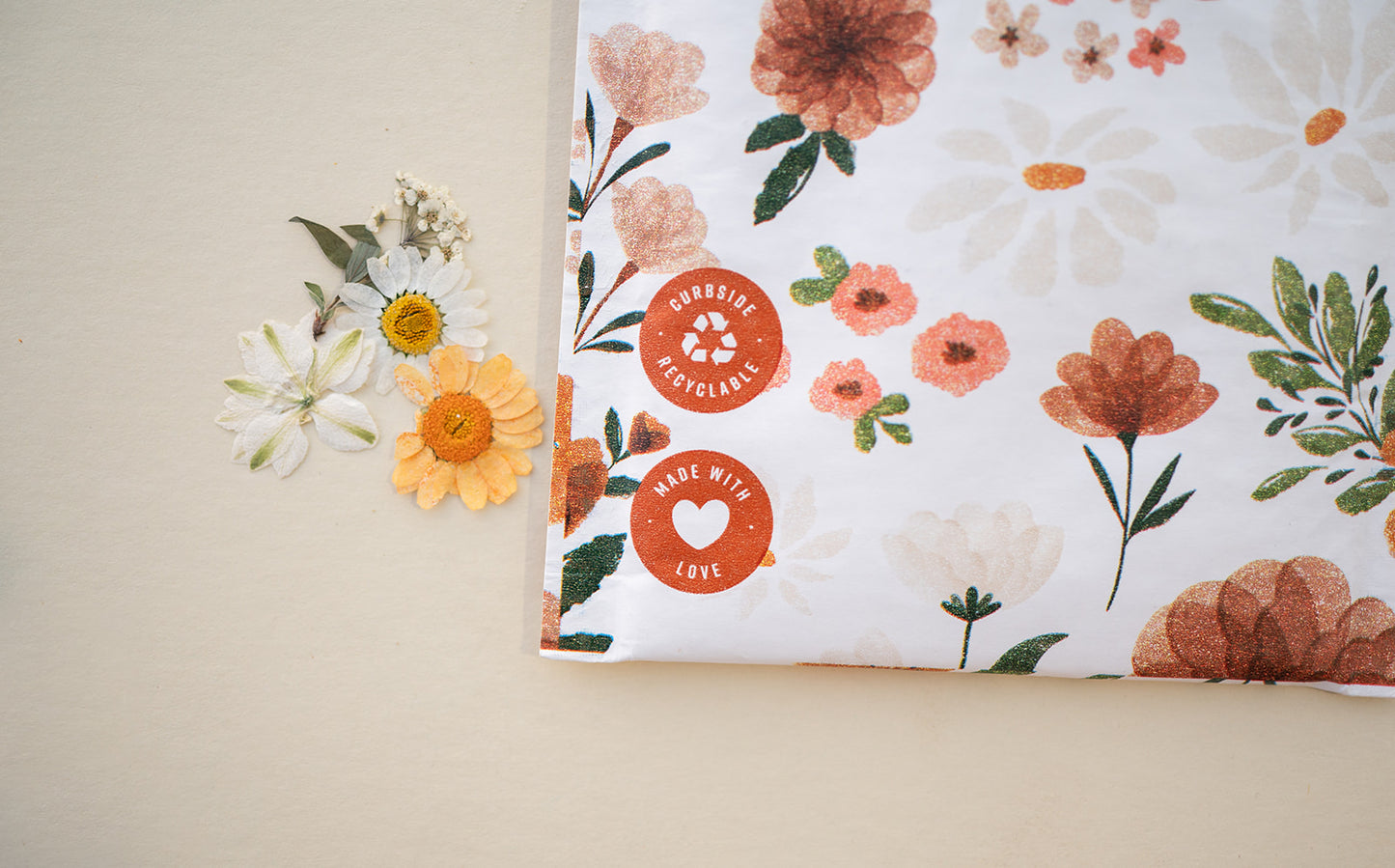 An eco-friendly Gardenlumina Padded Paper Mailer 6" x 9" adorned with flowers and an impack.co sticker.