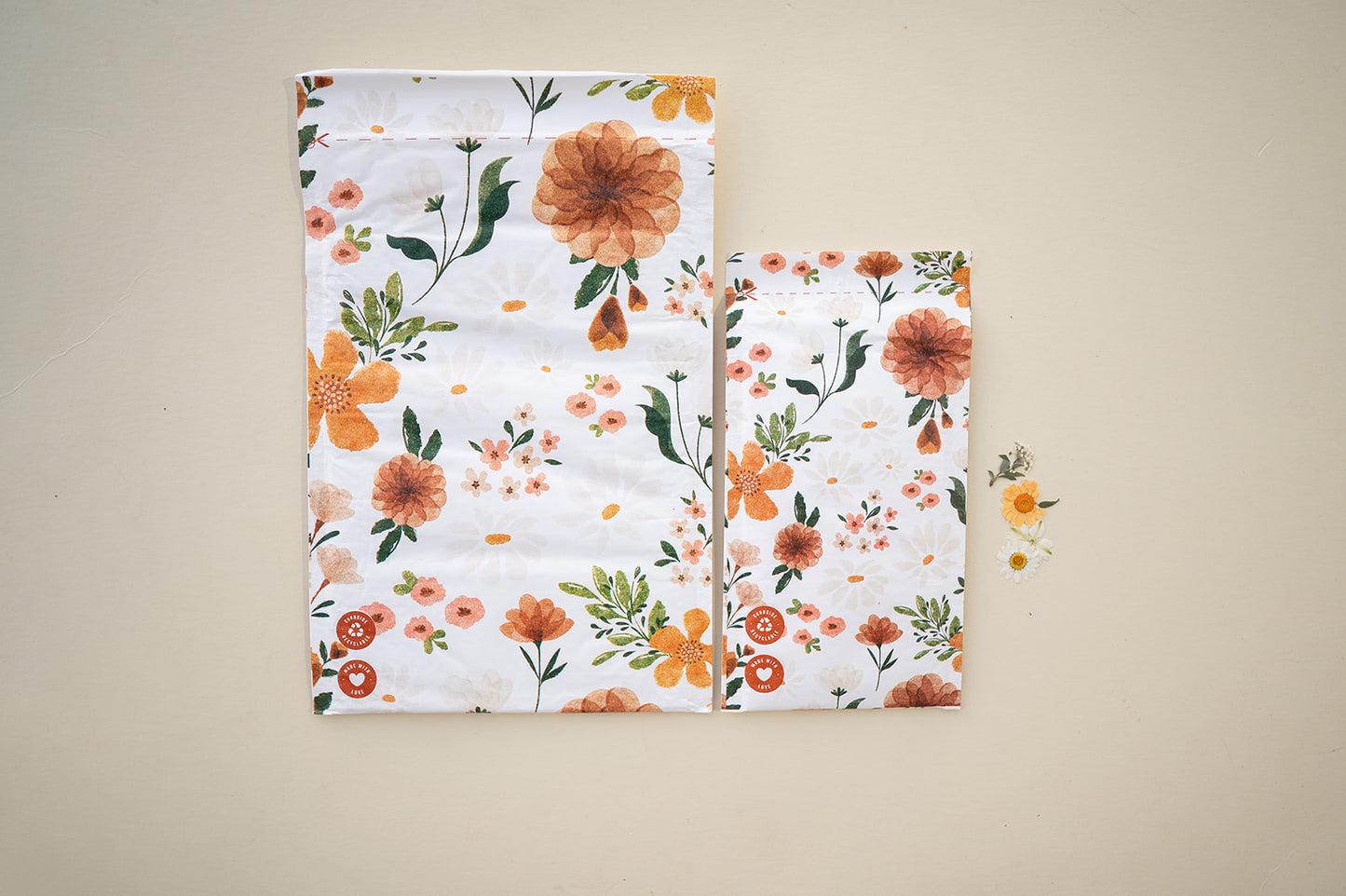 A bag with orange and white flowers on it, featuring honeycomb padding for extra protection during sustainable shipping - Gardenlumina Padded Paper Mailers 10" x 13" by impack.co.