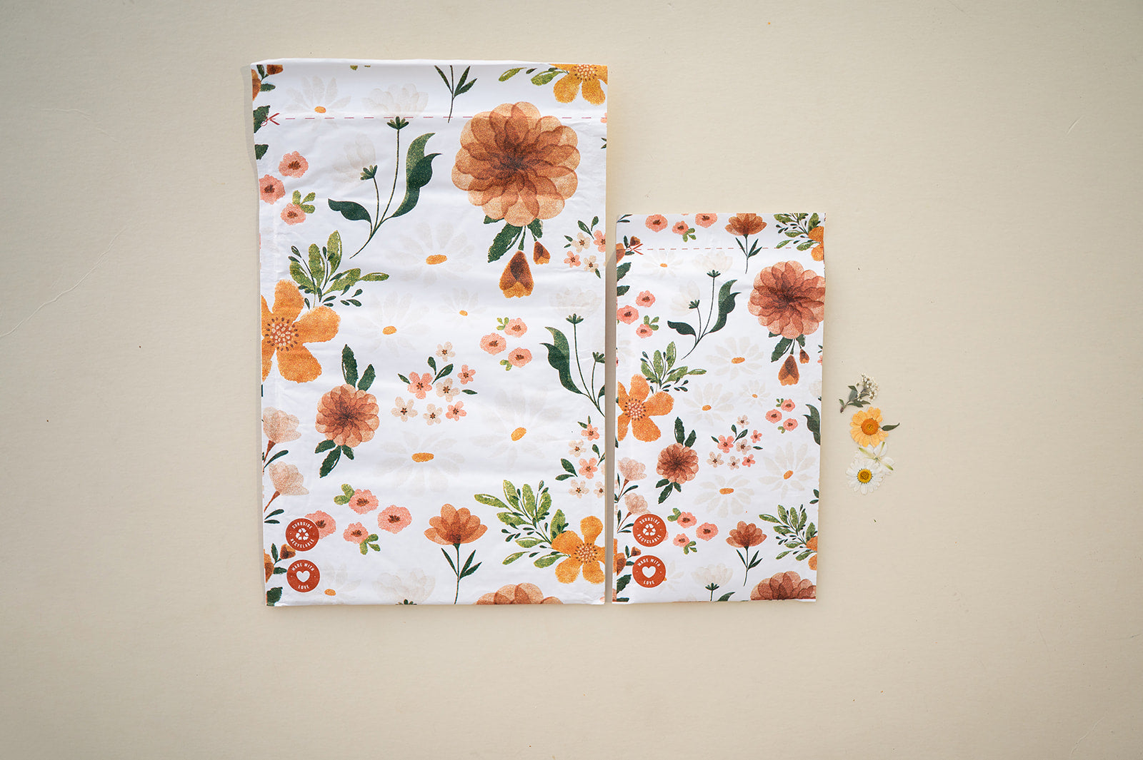 A Gardenlumina Padded Paper Mailer 6" x 9" from impack.co with orange and white flowers on it.