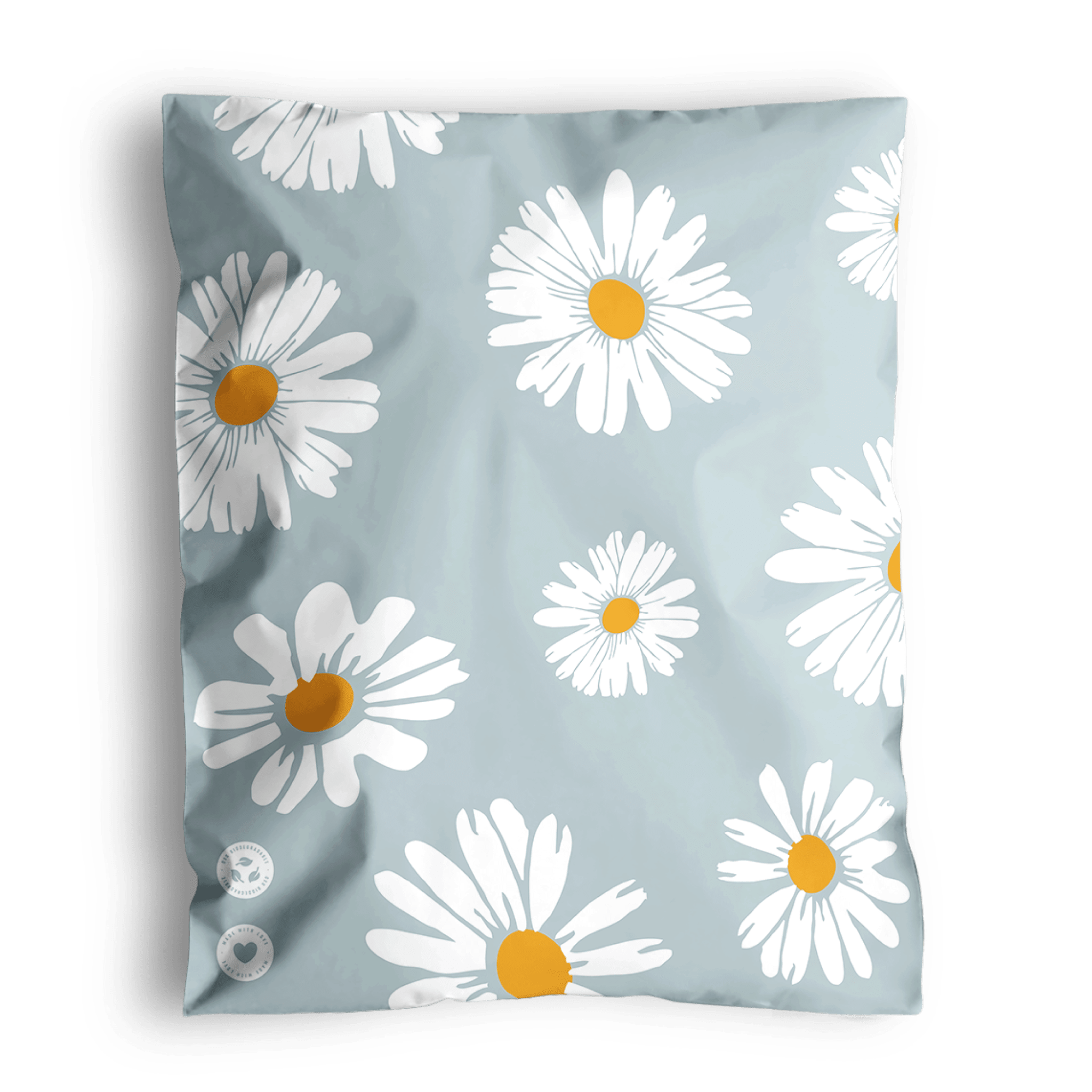 Cushion with daisy print design on a grey background, shipped in Daisy White Biodegradable Mailers 10" x 13" from impack.co.