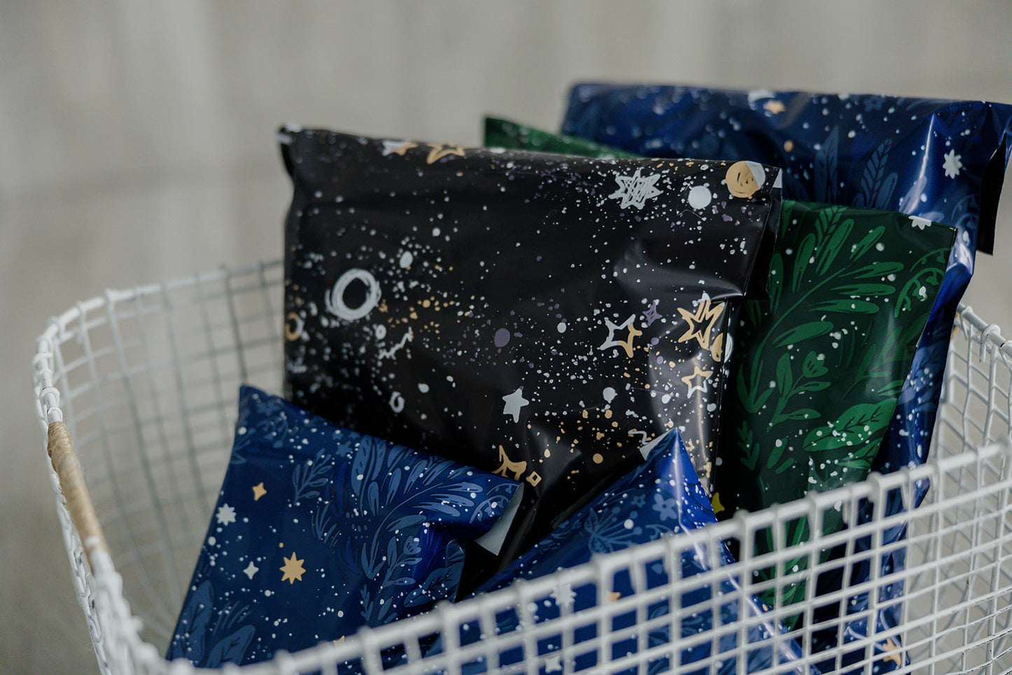 A basket full of Midnight Galaxy Mailers 10" x 13" by impack.co recyclable coffee bags.
