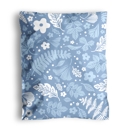 A patterned fabric with floral and leaf designs, perfect for creating Sapphire Evergreen Biodegradable Mailer Bags 10" x 13" by impack.co.