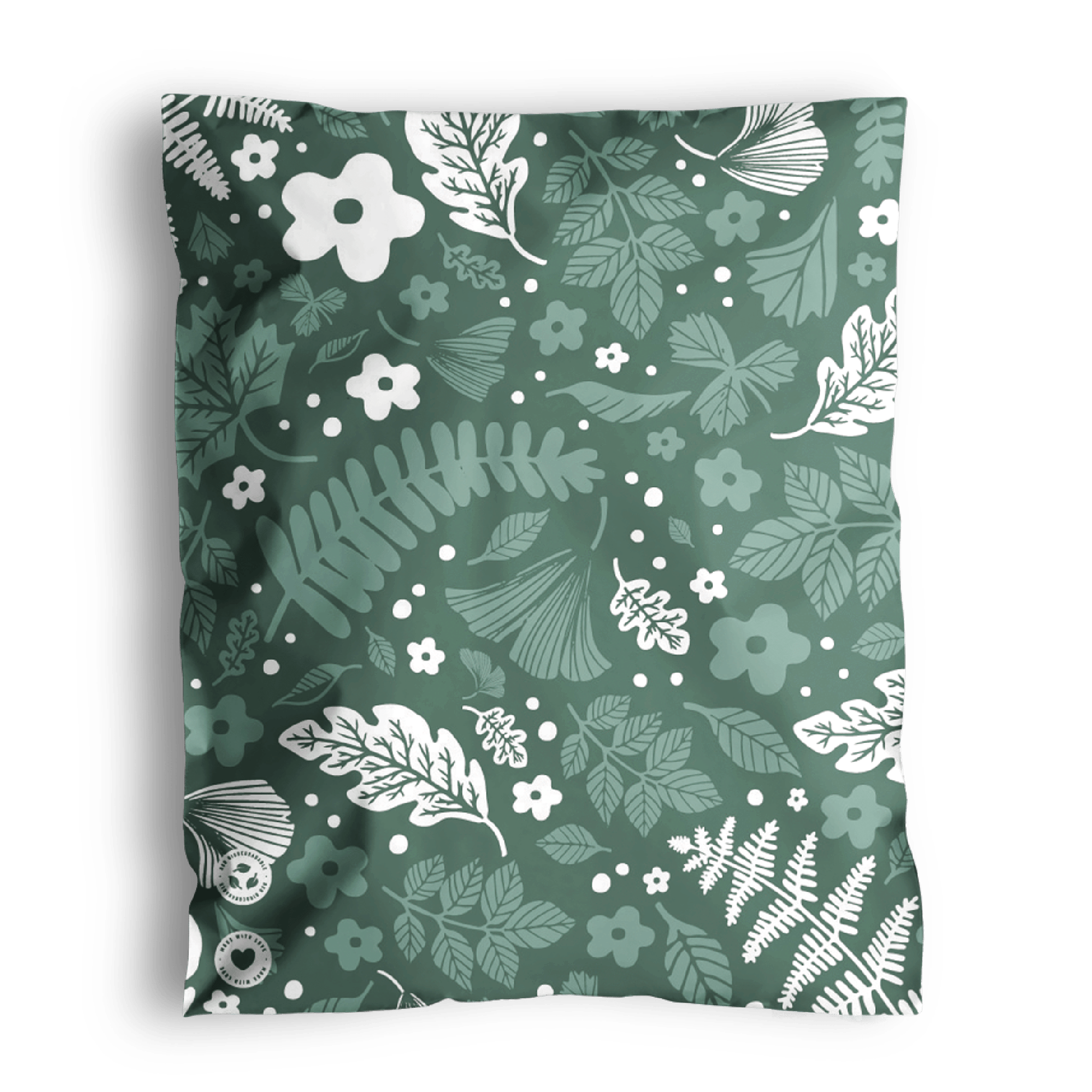 Decorative floral pattern on a fabric with a folded corner, wrapped in impack.co's Emerald Evergreen Biodegradable Mailers 10" x 13".