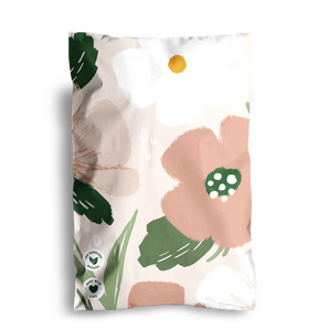 A floral-patterned packaging with large flowers in pink, green, and white hues. The Large Flowers Mailers 6" x 9" by impack.co are designed for storing small accessories and feature green certification stamps at the bottom left corner.