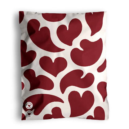 A cushion with impack.co's Red Hearts Biodegradable Mailers 10" x 13", perfect for Valentine Print Mailers.