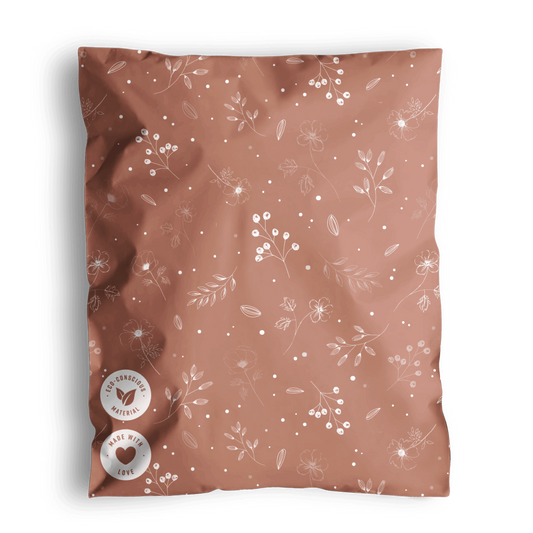 A patterned Floral 2D rosy brown fabric with a fabric tag, likely a swatch or textile sample, presented in impack.co biodegradable mailer bags.