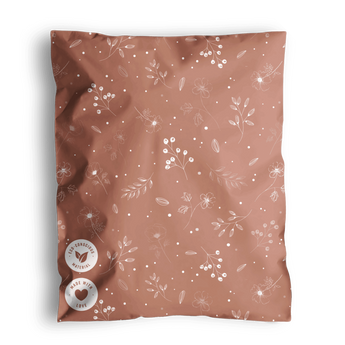 A patterned Floral 2D rosy brown fabric with a fabric tag, likely a swatch or textile sample, presented in impack.co biodegradable mailer bags.