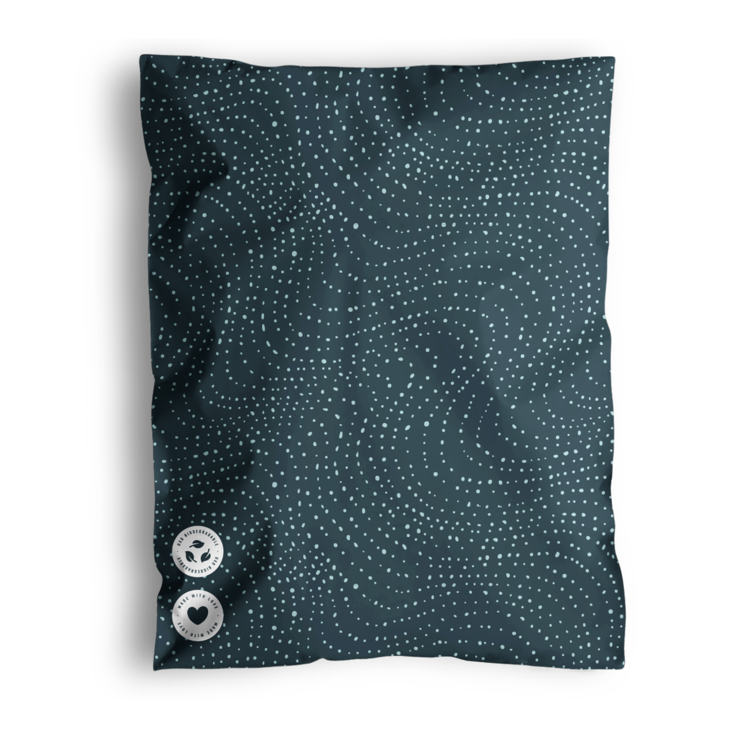 A blue pillow with a dotted wavy pattern and two buttons, shipped in impack.co's Wavy Dots Biodegradable Mailers 19" x 24%.
