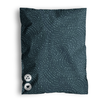 A blue pillow with a dotted wavy pattern and two buttons, shipped in impack.co's Wavy Dots Biodegradable Mailers 19" x 24%.