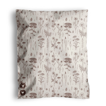 The Wildflower Biodegradable Mailers by impack.co, measuring 10" x 13", exude rustic charm with their beige fabric adorned with various brown floral and plant patterns.