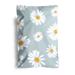A comforter with a daisy flower print design displayed against a dark background and shipped in impack.co's Daisy White Biodegradable Mailers 6" x 9".