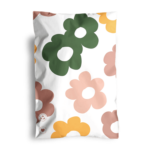 A Daisy Multicolor Biodegradable Mailers 6" x 9" pillow with a white background, shipped in impack.co mailer bags.