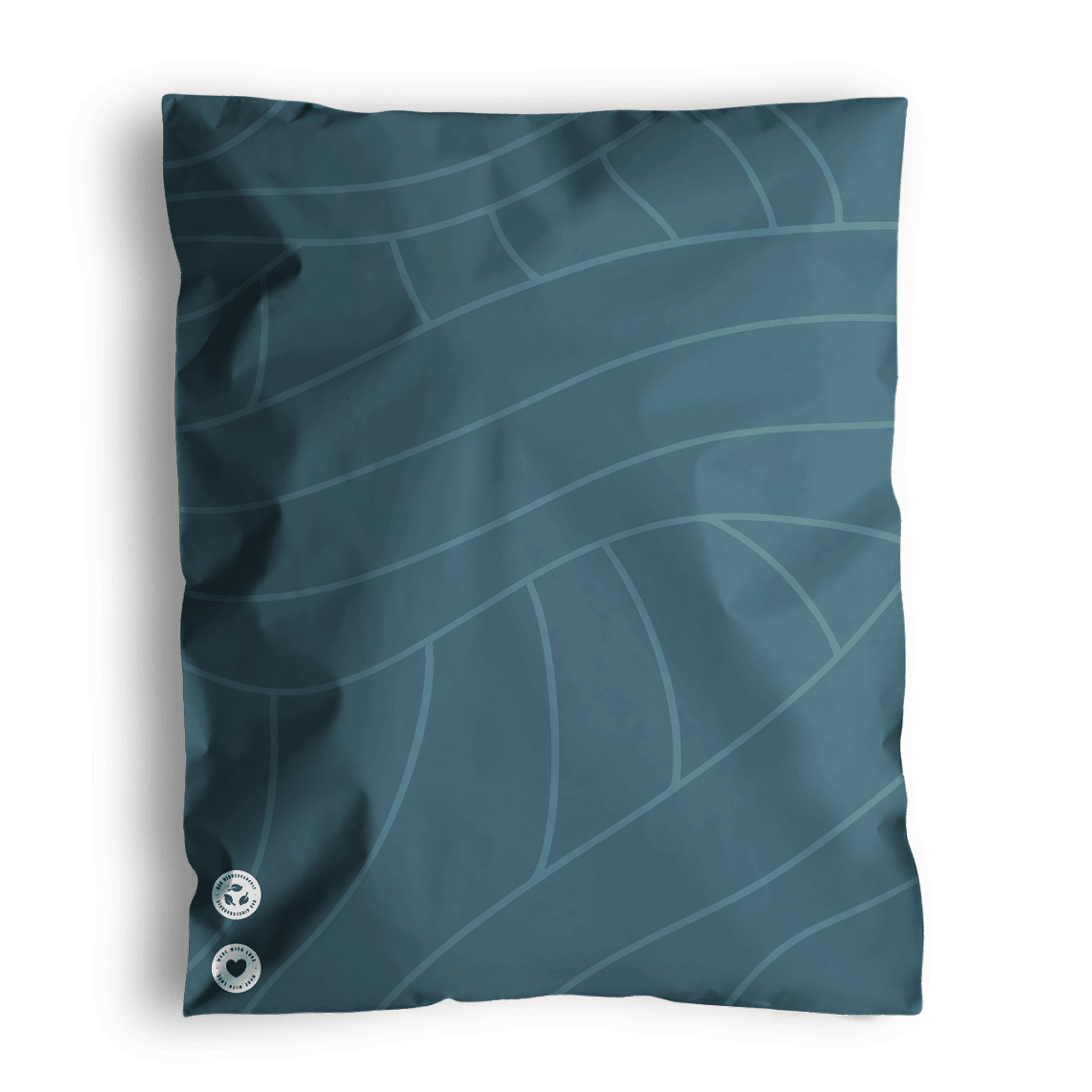 A Space Blue Leaf bed pillow with a leaf pattern design and two decorative buttons, resting on a similarly patterned impack.co recyclable surface.