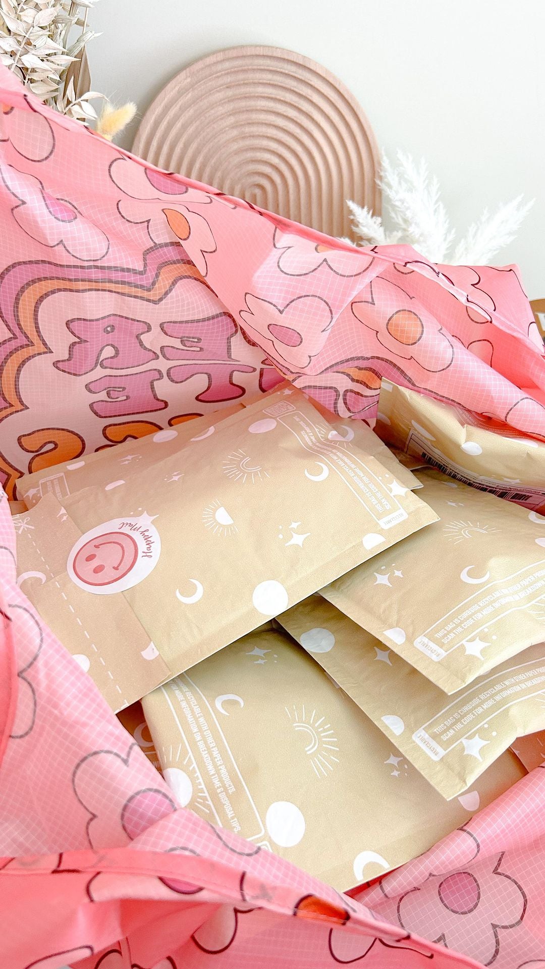 An eco-conscious Celestial Padded Paper Mailers 6" x 9" bag filled with pink and white paper from impack.co.