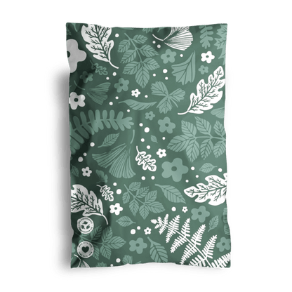Sentence with replaced product: A folded fabric with a green floral pattern and visible sewing buttons on one corner, designed as Emerald Evergreen Biodegradable Mailers 6" x 9 by impack.co.