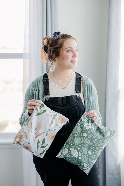 A woman in overalls holding two Biodegradable Mailers 10" x 13" from impack.co.