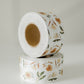 A roll of Packing Tape - Camelia Bloom by impack.co on a white surface.