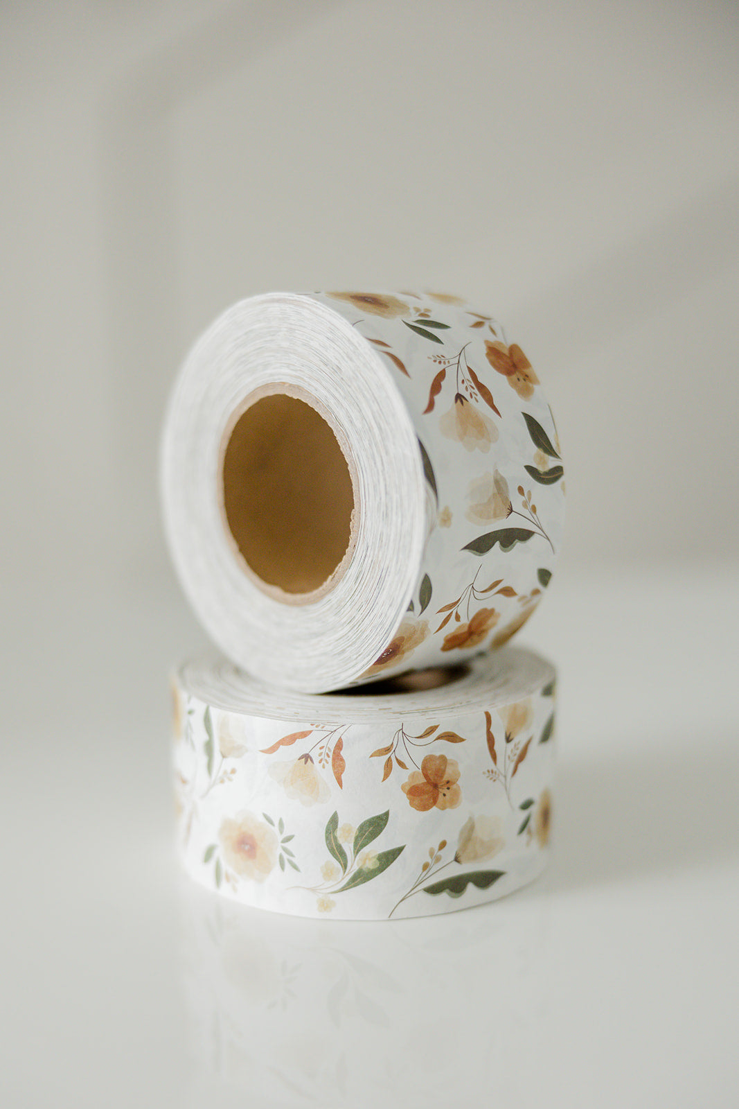A roll of Packing Tape - Camelia Bloom by impack.co on a white surface.