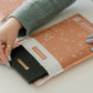 A woman is holding a Rosy Brown Biodegradable Bubble Mailers 6" x 9" from impack.co.