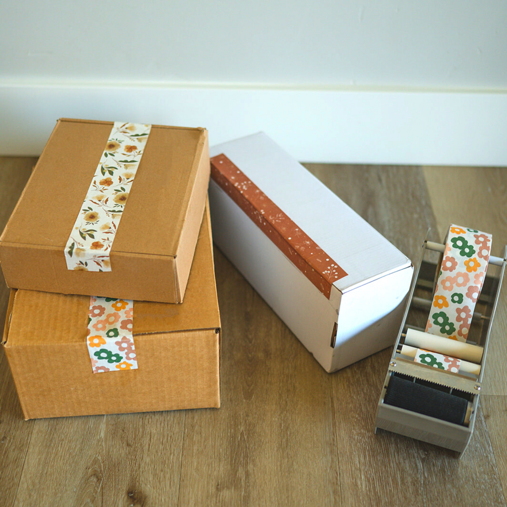 A box with a Packing Tape - Floral Rosy Brown tape dispenser